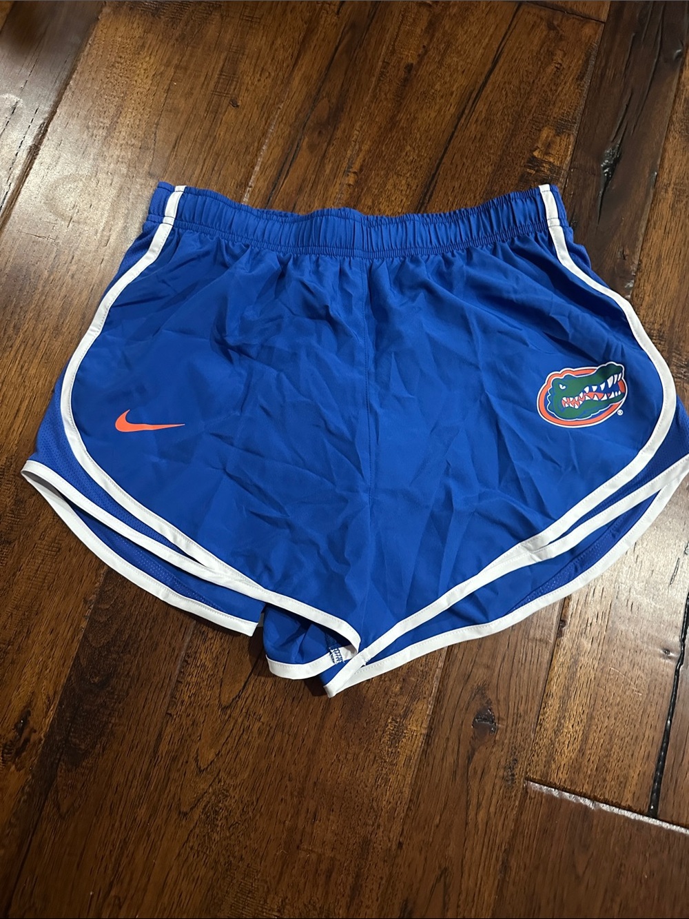 Nike Women's Royal Blue Athletic Shorts with Orange Swoosh and Team Patch